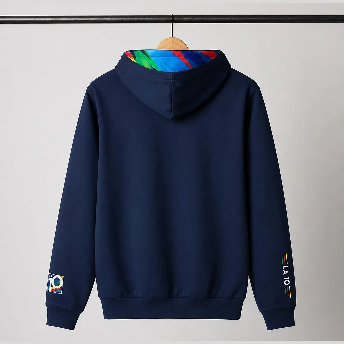 Back of the navy 2026 hoodie on a hanger: plain, with the colourful lining showing in the hood and LA 10 on the cuffs