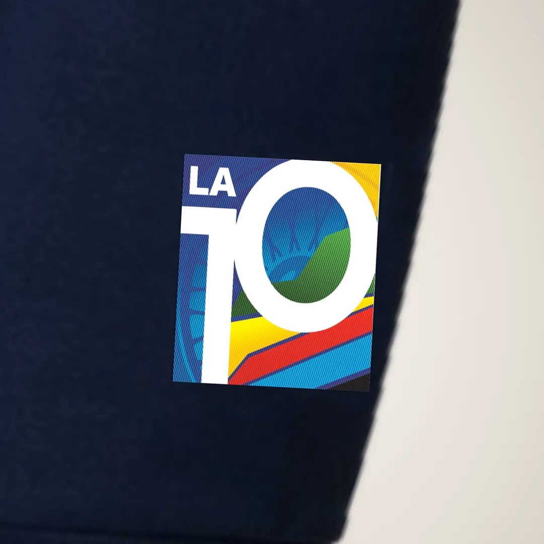 The La 10 crest embroidered on the cuff of the navy hoodie sleeve