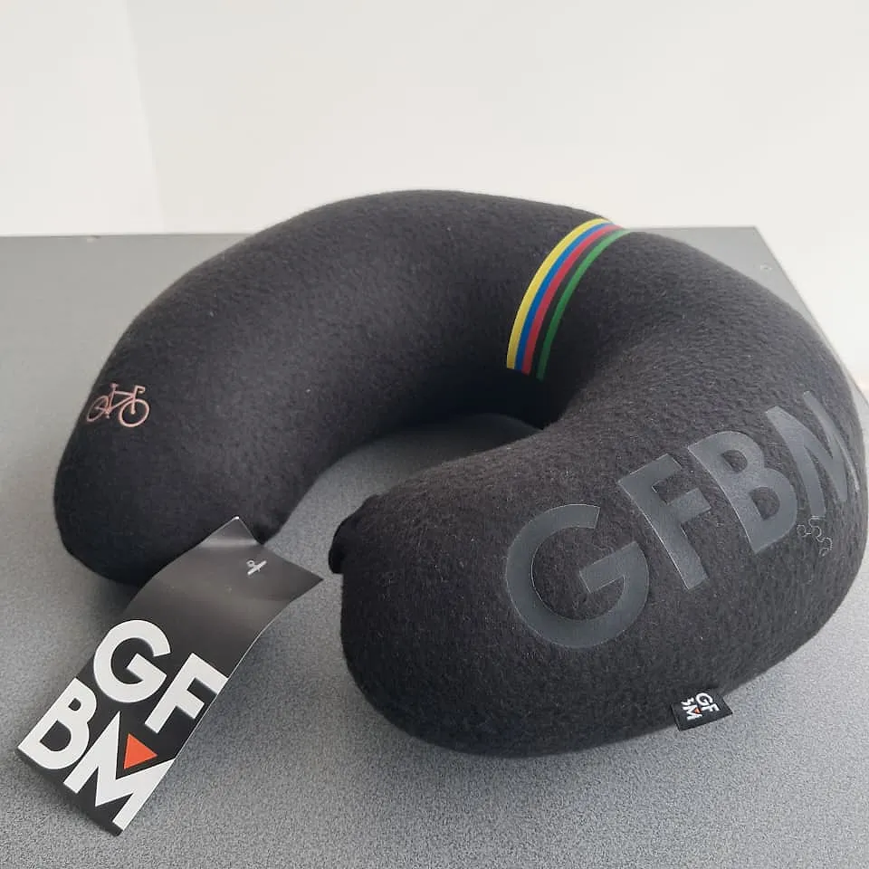Black U-shaped GFBM travel pillow, with GFBM embossed, an embroidered bicycle and the colour stripes