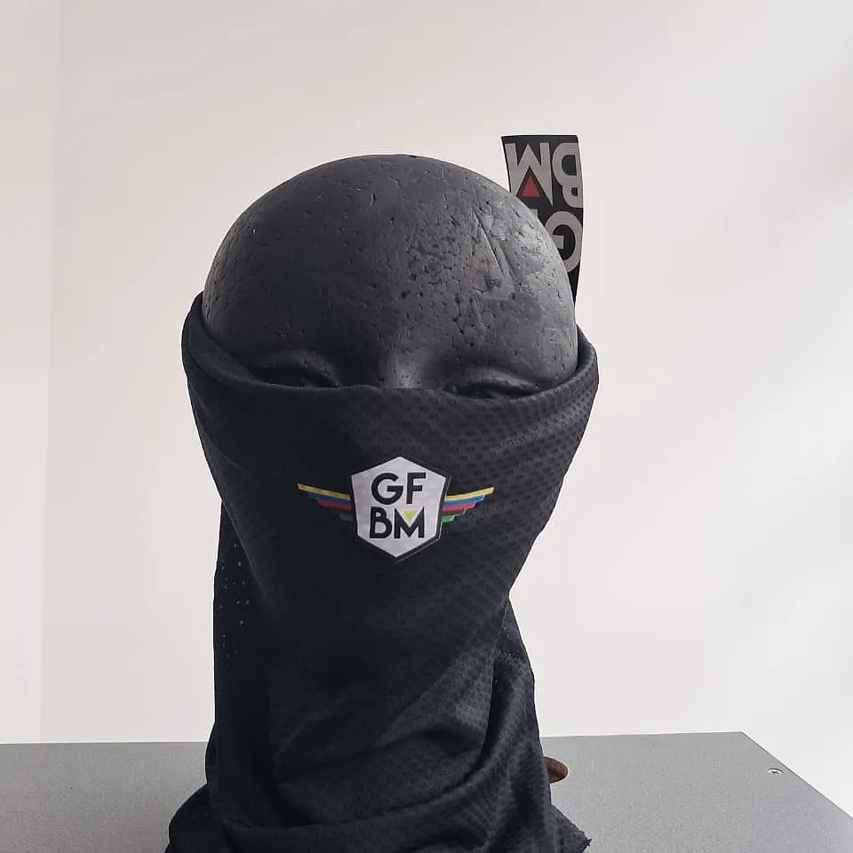 Black GFBM 2025 neck warmer on a mannequin, pulled up to the nose, with the GFBM crest at the front