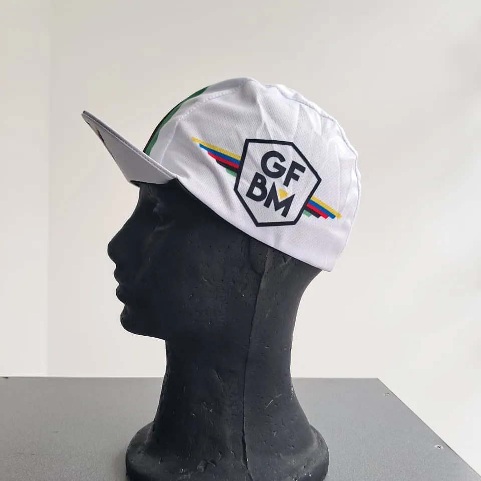White GFBM cycling cap seen from the side, with the peak and the colour stripes