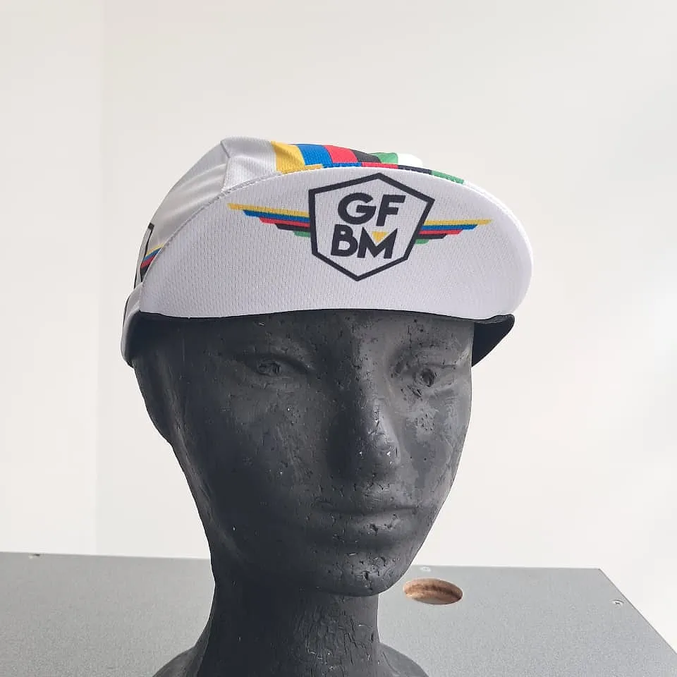 White GFBM cycling cap seen from the front, with the GFBM crest and the colour stripes