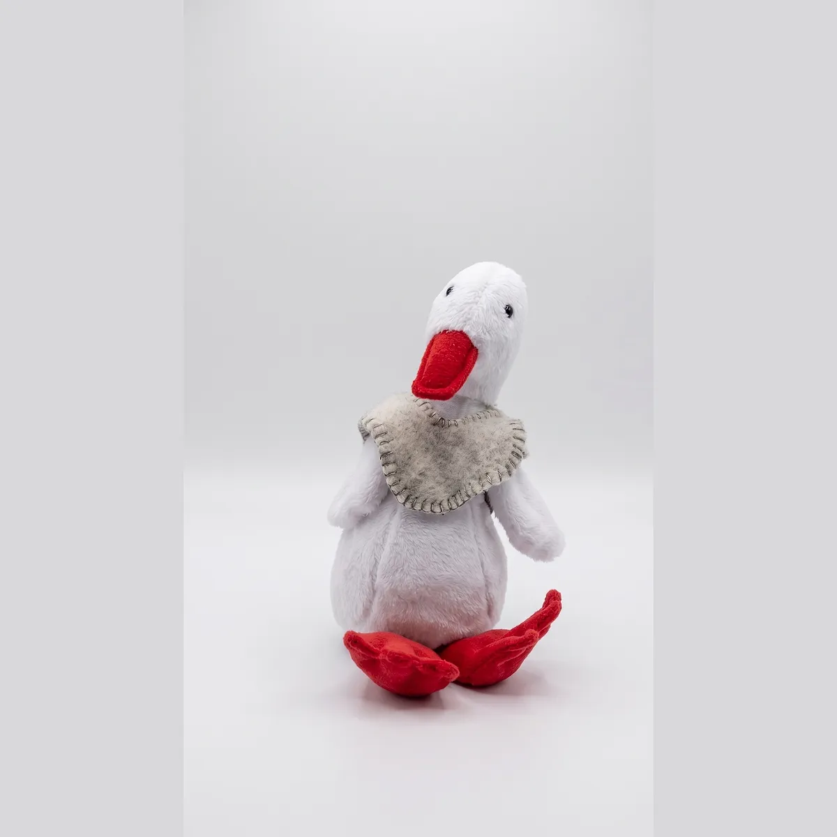 The same duck with the felt ruana worn over its shoulders