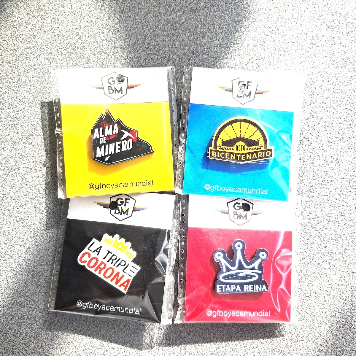 Four commemorative Gran Fondo pins in their bags: Alma de Minero, Reto Bicentenario, La Triple Corona and Etapa Reina